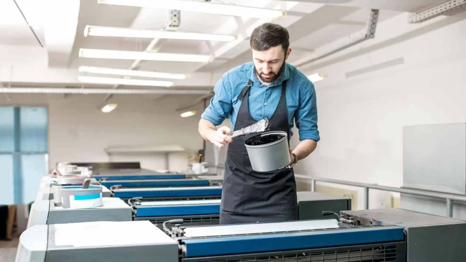 typographer-with-paint-at-the-manufacturing-e1751532419327-1536x866